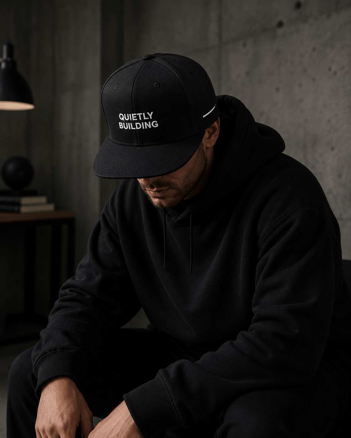 Man wearing TheCapTribe Quietly Building premium black snapback in minimalist streetwear setting