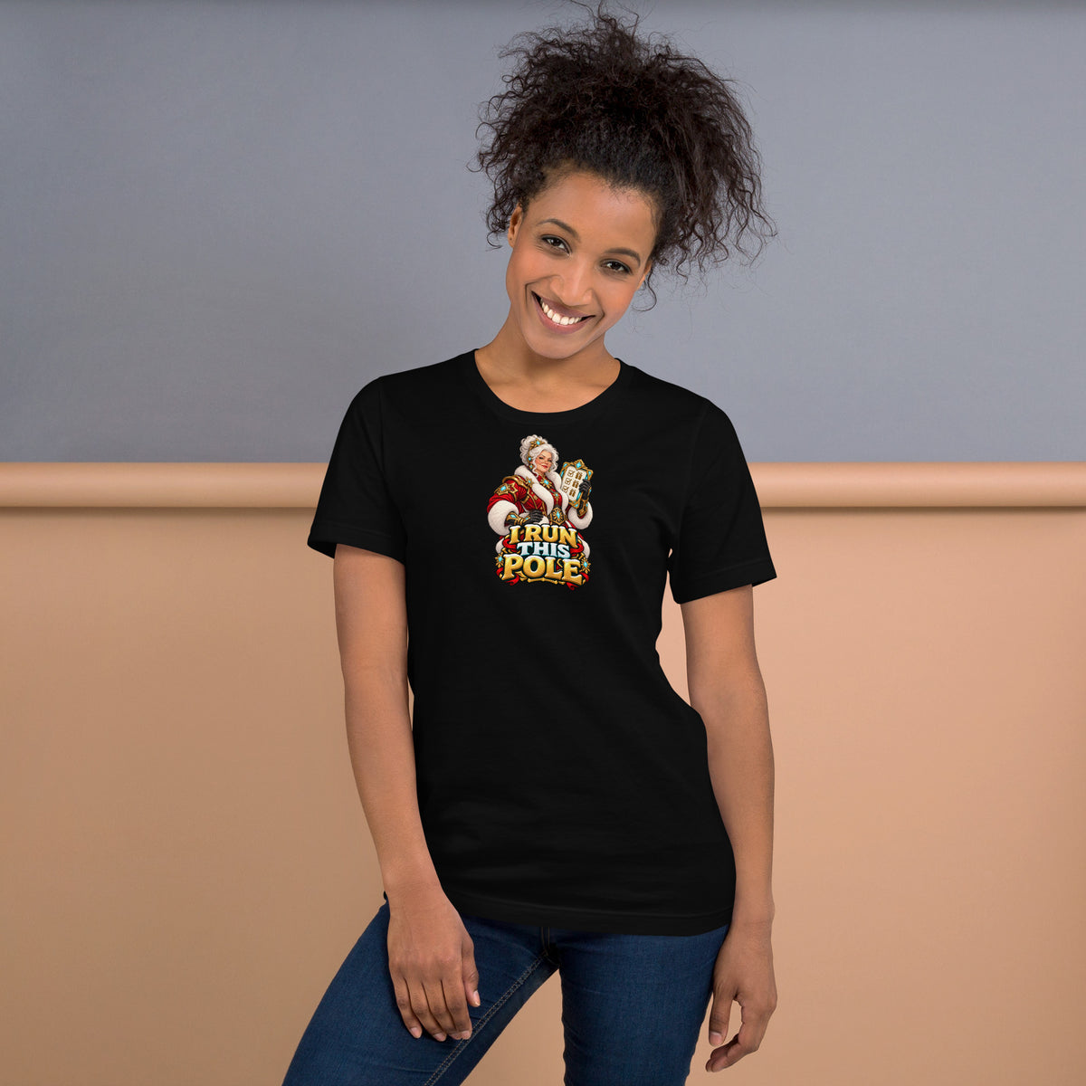 Official mockup of a woman wearing the black Bella + Canvas 3001 Christmas tee with Mrs. Claus and I RUN THIS POLE printed on the front.