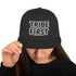 Front view of Tribe First snapback cap by TheCapTribe™, premium black streetwear hat with bold white embroidery
