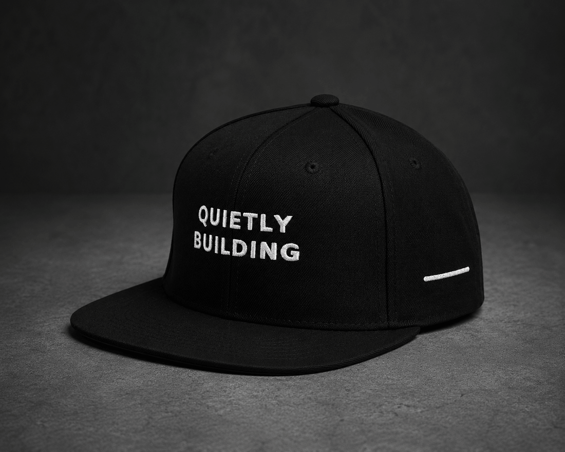 Back view of TheCapTribe Quietly Building black snapback showing Results Speak embroidery