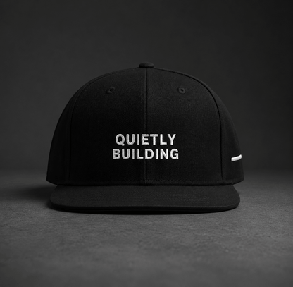 TheCapTribe Quietly Building black premium snapback with white 3D puff embroidery front view