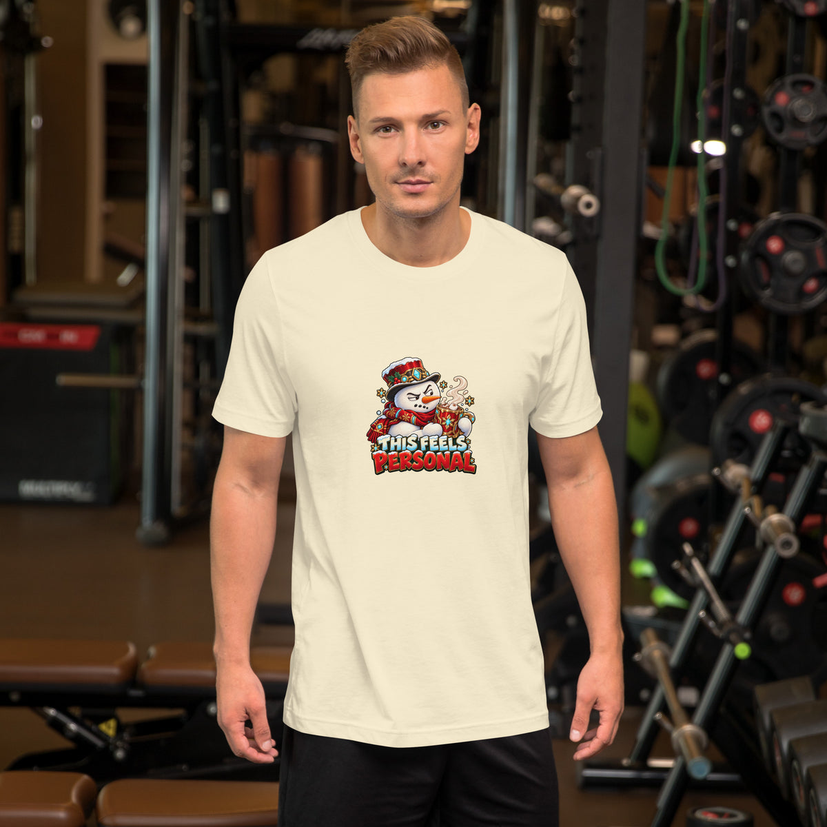 Man wearing a Natural Bella + Canvas 3001 T-shirt with the colorful “This Feels Personal” snowman Christmas design.